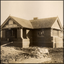 A sepia tone photo of a small house